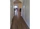 Inviting hallway with hardwood floors, seamlessly connecting living spaces, and leading to the dining area at 3828 Dandridge Way, Duluth, GA 30096