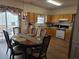 Spacious eat-in kitchen with stainless steel appliances, wood cabinetry, and a sliding door to the backyard at 3828 Dandridge Way, Duluth, GA 30096