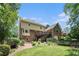 Expansive backyard showcasing lush greenery, a well-maintained lawn, and an outdoor living area with a deck at 751 Yorkshire Sw Pl, Lilburn, GA 30047