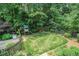 Lush backyard featuring a play set, swing, and a well-manicured lawn, perfect for outdoor activities at 751 Yorkshire Sw Pl, Lilburn, GA 30047