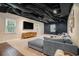 Finished basement featuring carpet, a sectional couch, flat screen TV, and a workout area with a treadmill at 751 Yorkshire Sw Pl, Lilburn, GA 30047