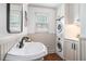 Bathroom with a stylish sink, stacked washer/dryer, and painted wall paneling at 751 Yorkshire Sw Pl, Lilburn, GA 30047