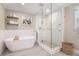 Modern bathroom featuring a soaking tub, a walk-in glass shower, and stylish fixtures at 751 Yorkshire Sw Pl, Lilburn, GA 30047