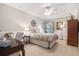 Comfortable bedroom featuring a ceiling fan, carpet, and stylish furnishings, including a desk, dresser and end tables at 751 Yorkshire Sw Pl, Lilburn, GA 30047