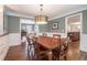 Stylish dining room featuring hardwood floors, stylish lighting, and seamless access to the kitchen at 751 Yorkshire Sw Pl, Lilburn, GA 30047