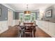 Formal dining area with hardwood floors, a large table, and views of the manicured backyard at 751 Yorkshire Sw Pl, Lilburn, GA 30047