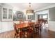 Elegant dining room with hardwood floors, custom cabinetry, and stylish lighting fixture at 751 Yorkshire Sw Pl, Lilburn, GA 30047