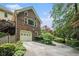 Brick house with a two-car garage, upper-level windows, and a landscaped driveway offers curb appeal at 751 Yorkshire Sw Pl, Lilburn, GA 30047