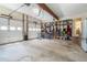 Spacious two-car garage with ample storage, open shelving, and bright lighting, ideal for organization and projects at 751 Yorkshire Sw Pl, Lilburn, GA 30047