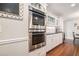 Modern kitchen featuring stainless steel appliances, white cabinets, and hardwood floors at 751 Yorkshire Sw Pl, Lilburn, GA 30047