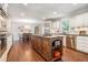 A spacious kitchen features an island with dark countertops, stainless steel appliances, and hardwood floors at 751 Yorkshire Sw Pl, Lilburn, GA 30047
