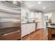 Bright kitchen featuring stainless steel appliances, white cabinets, and hardwood floors at 751 Yorkshire Sw Pl, Lilburn, GA 30047
