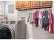 Well organized laundry room with front load washer and dryer and hanging rack for clothing at 751 Yorkshire Sw Pl, Lilburn, GA 30047