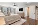 Bright main bedroom featuring a large window, hardwood floors, and stylish furnishings at 751 Yorkshire Sw Pl, Lilburn, GA 30047