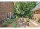 Side yard is nicely landscaped with a stone path alongside the exterior brick wall of the house at 751 Yorkshire Sw Pl, Lilburn, GA 30047