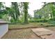 Landscaped backyard featuring mature trees, green foliage, and stone hardscaping at 1626 Oak Knoll Se Cir, Atlanta, GA 30315