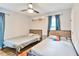 Bedroom featuring two beds, hardwood floors, ceiling fan, and neutral wall colors at 1626 Oak Knoll Se Cir, Atlanta, GA 30315