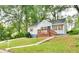 Charming home with a well-manicured lawn, inviting front porch, and quaint architectural details at 1626 Oak Knoll Se Cir, Atlanta, GA 30315