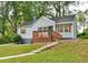 Exterior home showcasing a well-kept lawn, walkway steps, and a cozy front porch at 1626 Oak Knoll Se Cir, Atlanta, GA 30315