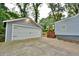 Detached two-door garage with gray siding and concrete driveway at 1626 Oak Knoll Se Cir, Atlanta, GA 30315