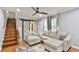 Comfortable living room featuring hardwood floors, a ceiling fan, and natural light from the windows at 1626 Oak Knoll Se Cir, Atlanta, GA 30315
