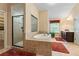 Bathroom featuring a tiled shower, large tub, and spacious vanity area at 305 Spooner Dr, Mcdonough, GA 30252