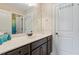 Bathroom featuring dark wood cabinets, white countertops, and a large mirror at 305 Spooner Dr, Mcdonough, GA 30252