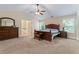 Bedroom with a ceiling fan, dresser, and a glimpse of the bathroom at 305 Spooner Dr, Mcdonough, GA 30252