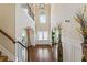 Grand two-story foyer with hardwood floors, arched doorways, and lots of natural light from above window at 305 Spooner Dr, Mcdonough, GA 30252