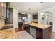 Large kitchen with dark cabinets, stainless appliances, granite countertops, and an island with seating at 305 Spooner Dr, Mcdonough, GA 30252