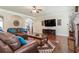 Comfortable living room with leather sofas, large screen TV, and a ceiling fan at 305 Spooner Dr, Mcdonough, GA 30252
