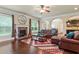 Spacious living room with a fireplace, hardwood floors, and comfortable seating, ideal for relaxation at 305 Spooner Dr, Mcdonough, GA 30252