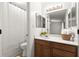 Bathroom featuring a wood vanity, updated light fixtures, and shower with white curtain at 4941 Meadow Lane, Marietta, GA 30068