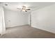 Spacious bedroom with neutral carpet, a ceiling fan, and a convenient adjacent doorway at 4941 Meadow Lane, Marietta, GA 30068