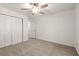 Comfortable bedroom featuring neutral carpet, a ceiling fan, and a closet at 4941 Meadow Lane, Marietta, GA 30068