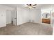 Spacious bedroom with soft carpet, neutral paint, and a ceiling fan, leading to a bathroom at 4941 Meadow Lane, Marietta, GA 30068