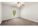 Bedroom featuring neutral carpet, ceiling fan, and natural light from the window at 4941 Meadow Lane, Marietta, GA 30068