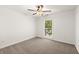 Bright bedroom with neutral carpet, ceiling fan, and natural light from the window at 4941 Meadow Lane, Marietta, GA 30068