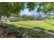 A shared green space is surrounded by mature trees and well-manicured shrubs and greenery at 4941 Meadow Lane, Marietta, GA 30068