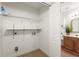 Functional laundry area with shelving plus a glimpse of the adjacent powder room at 4941 Meadow Lane, Marietta, GA 30068
