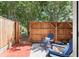 Outdoor patio with a privacy fence and comfortable blue chairs in a serene setting at 4941 Meadow Lane, Marietta, GA 30068