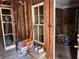 Interior showcasing exposed studs, original windows, and a view into an adjacent room under renovation at 2058 North Nw Ave, Atlanta, GA 30318