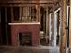 Home under renovation featuring a brick fireplace and exposed wood framing at 2058 North Nw Ave, Atlanta, GA 30318