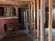 Interior view of a home under renovation, featuring a brick fireplace and exposed wood framing at 2058 North Nw Ave, Atlanta, GA 30318