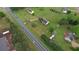A lush residential area showing a long stretch of black asphalt road, flanked by homes and mature trees at 2068 Hampton Locust Grove Rd, Locust Grove, GA 30248