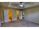 Spacious bedroom featuring a ceiling fan, neutral tones, and access to a bathroom and closet at 2068 Hampton Locust Grove Rd, Locust Grove, GA 30248