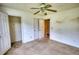 Bedroom boasts a ceiling fan, a closet, and doorway to another room at 2068 Hampton Locust Grove Rd, Locust Grove, GA 30248
