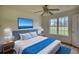 Bright bedroom features a ceiling fan, a large window, and a plush bed at 2068 Hampton Locust Grove Rd, Locust Grove, GA 30248