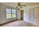 Bedroom boasts a ceiling fan, a closet, and natural light from the window at 2068 Hampton Locust Grove Rd, Locust Grove, GA 30248