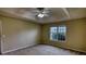 Bedroom with a ceiling fan, a large window, and neutral-colored walls and carpeting at 2068 Hampton Locust Grove Rd, Locust Grove, GA 30248